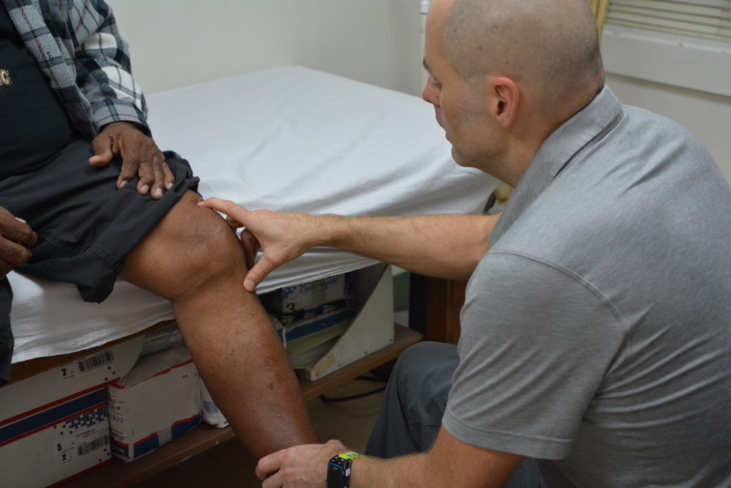 Brad Crow examining a patient (1)